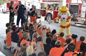 Sparky the Fire Dog talking to a group of children